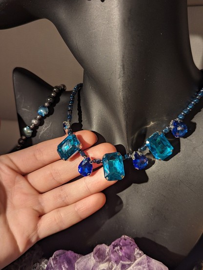 Handmade blue set with necklace with 3 light blue large rectangular pendants and blue drop pendants 
Bracelet with hematite styled beads and light blue shell shaped beads
