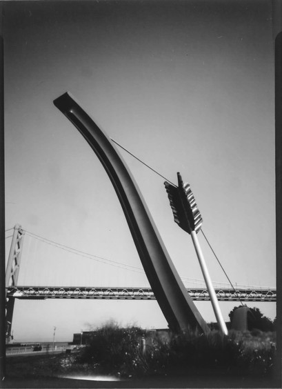 A black and white pinhole photo of the Cupid's Bow sculpture on the SF Embarcadero