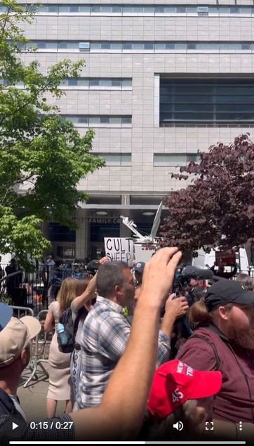 Anti-Trump protesters in front of the NYC court, one of them holding a sign, reading: "Cult Sheep" to the Trump-surrogates, that try to speak on behalf of Trump to the public outside.