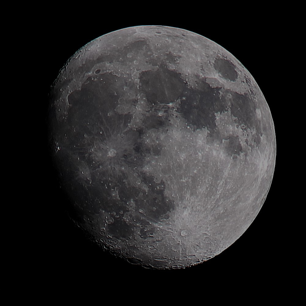 The Moon at waxing Gibbous phase on a dark background. 