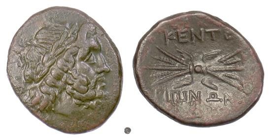 Photograph of two sides of a silver coin. On the left the coin shows the laureate head of Zeus facing right, depicted with a full beard and braided hair. On the right the reverse side shows a winged thunderbolt with Greek letters inscribed above and below it.