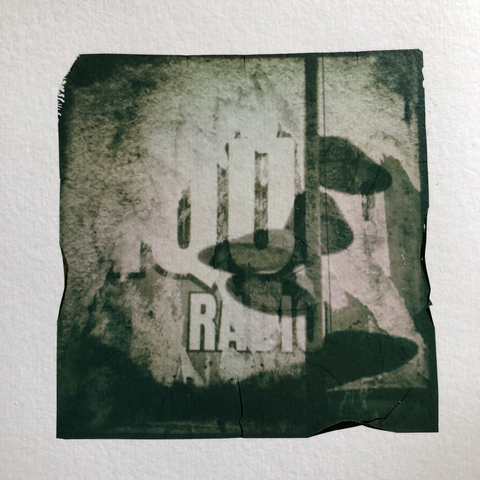Double exposure photo : city lights and ripped posters on the city walls. Polaroid emulsion lift.
