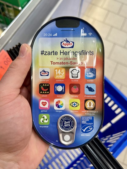 Eine Fischkonserve „#zarte Heringsfilets > in pikanter Tomaten-Sauce ;)“ von Appel, mit einem Deckel ähnlich einem iPhone-Homescreen mit Uhrzeit und Batteriestand und einem Raster mit App-Icons, wobei sich die verschiedenen App-Icons auf Eigenschaften des Produkts (»pikant«, »Proteinquelle«, »tomatig«) sowie anderen Unsinn (»fotogen«, »guckst du«) beziehen.