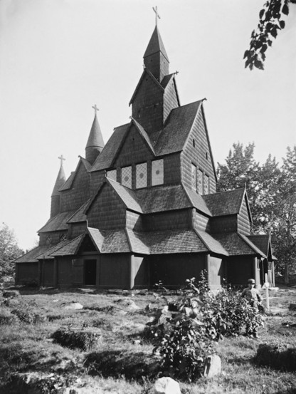 klassische holzkirche (stabkirche) aus norwegen mit dunklem holz und vielen verwinkelten dachschrägen