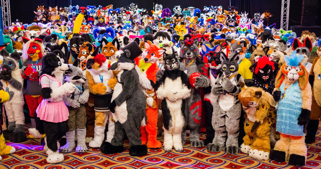An enormous gathering of several hundred fursuits in a hotel ballroom. The colours are highly saturated, bringing out the toony qualities of the costumes.