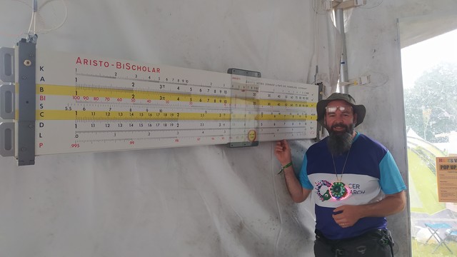 Beardy me next to a huge maybe 3 meter long sliderule. 
 