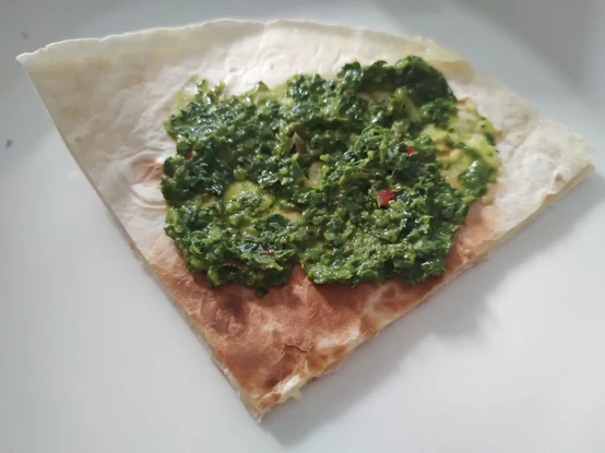 Cheese wrap with a green dip made of parsley and chili