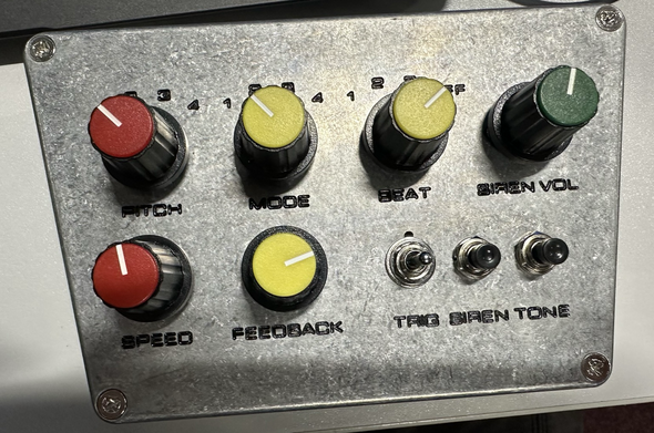 A dub siren.  A metal box with coloured knobs on it