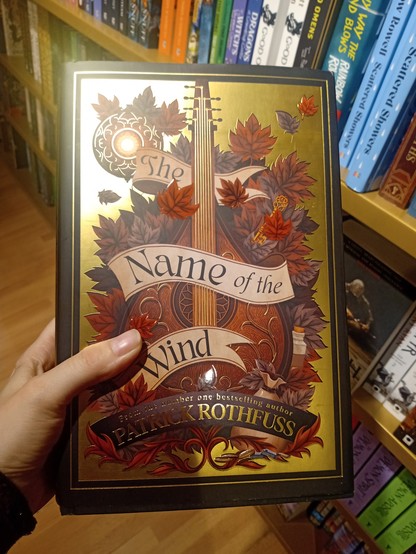 Book cover. A Golden shining material, a lute with autumn leaves around it
