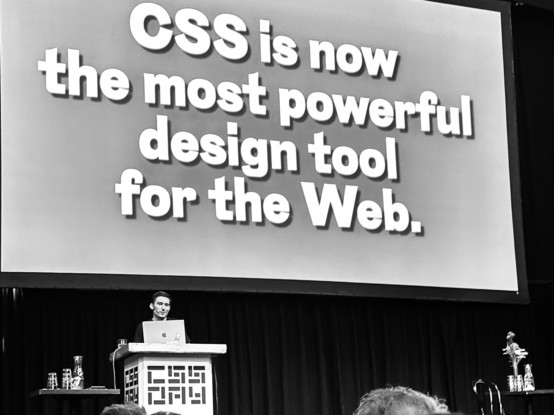 Matthias Ott on the stage of CSS Day. Slide content: ”CSS is now the most powerful design tool for the Web.“