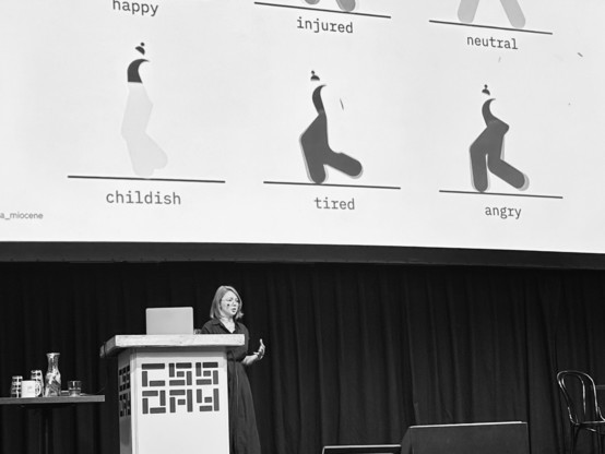 Julia Miocene on CSS Day stage showing a slide showcasing different mood solely through the movement of a walking character. 