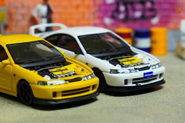 Honda Integra Type R (DC2) Spoon Sports yellow and white by Nice Auto opened car hood to see engine bay in 1:64 scale with 1:64 figure on AREA 164
