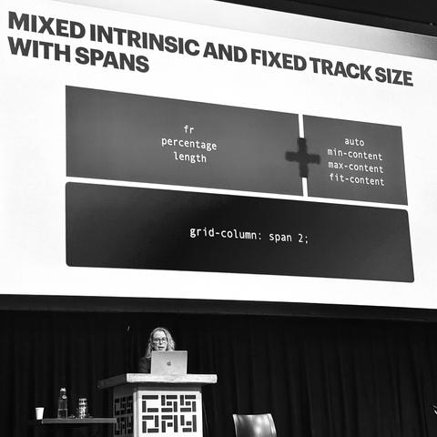 Nicole on stage. Slide content: MIXED INTRINSIC AND FIXED TRACK SIZE WITH SPANS