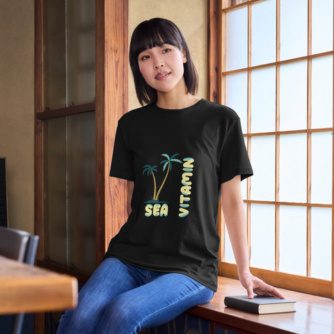 Playful palm leaf typography spelling "Vitamin Sea" on a t-shirt mockup. Download the free vector file and create your own summer shirt!