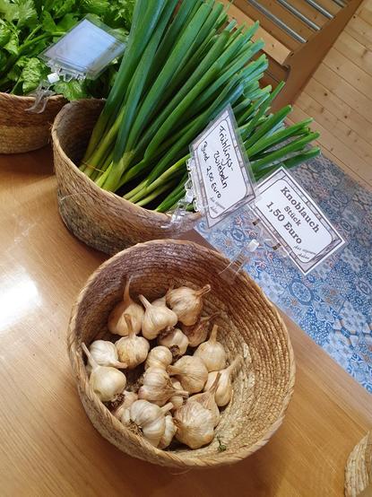 Knoblauchknollen für je 1,50 EUR. Frühlingszwiebeln, ein Bund für 2 EUR.