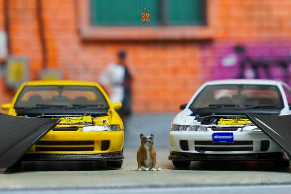 A dog with Honda Integra Type R (DC2) Spoon Sports yellow and white by Nice Auto opened car hood to see engine bay in 1:64 scale with 1:64 figure on AREA 164