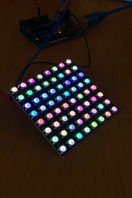 A 64 LED matrix connected to an Arduino microcontroller, randomly showing different RGB colors