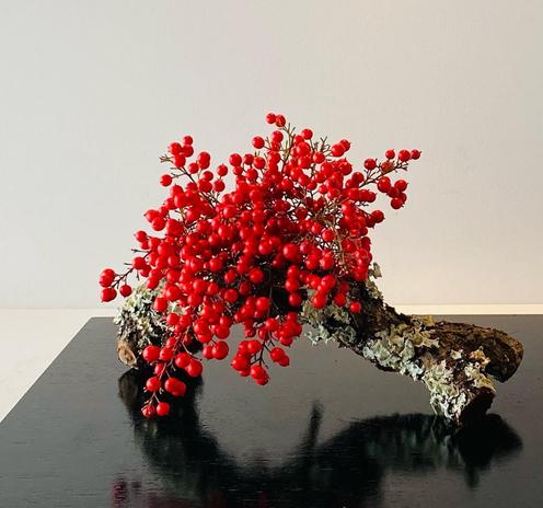 For winters a spray of berries. Instead of a vase, an old, lichen covered piece of branch.