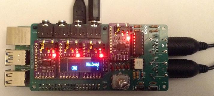 Photo of a custom PCB on a Raspberry Pi 5.  The PCB includes four GY-PCM5102 modules, four TRS outputs, MIDI connectors, and a OLED display showing"MiniDexed" and "TG8"