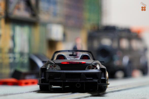 A rear side of Honda S2000 Race Car, Voltex Time Attack by Micro Turbo in 1:64 scale with 1:64 figure on AREA 164