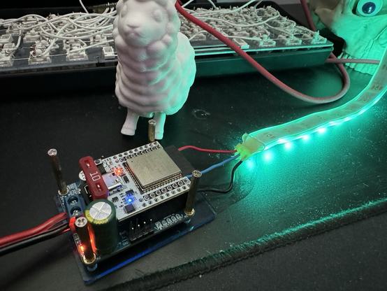 A QuinLed Dig Uno Esp32 carrier board for WLED sitting next to a 3d printed Llama.