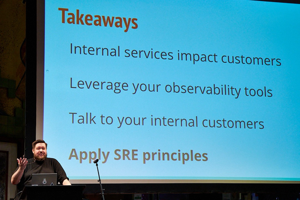 Speaker in front of slide, text in post