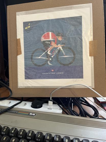 Photo of a packed print of Danish pro cyclist Cecilie Uttrup Ludwig in Danish champion outfit at Tour de France Femmes