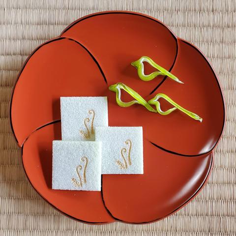 Sugar spun into the shape of Japanese bush warblers, and a wafer emblazoned with fresh bracken buds.