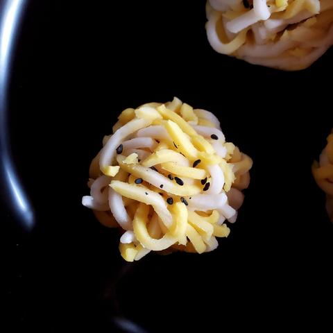 A tiger inspired kinton (yellow and white, with black sesame seeds).