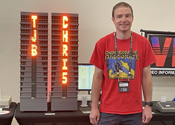 TJBChris standing next to a model of Tandy Center with his name spelled out in lights. 