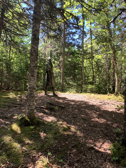 Sculpture of a Beothuk woman in a Birch Forest.