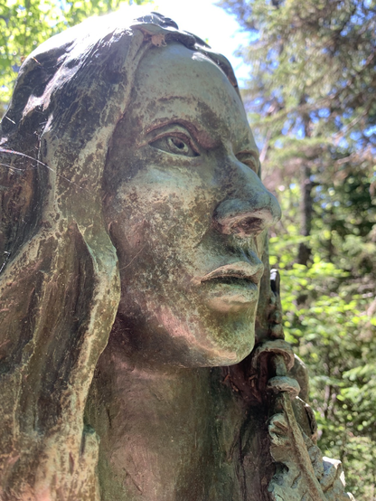 Sculpture of a Beothuk woman in a Birch Forest.