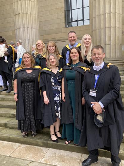 EduAT graduates with Rohan in academic dress in the Caird hall steps 