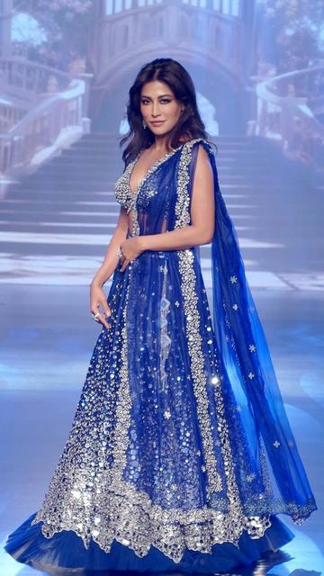 Stealing the spotlight at Delhi Times Fashion Week, Chitrangda Singh dazzled in a blue lehenga. The ensemble featured intricate detailing and a vibrant color, perfectly showcasing her chic and elegant style. Her look was a perfect blend of traditional elegance and contemporary fashion, making waves in the fashion world.