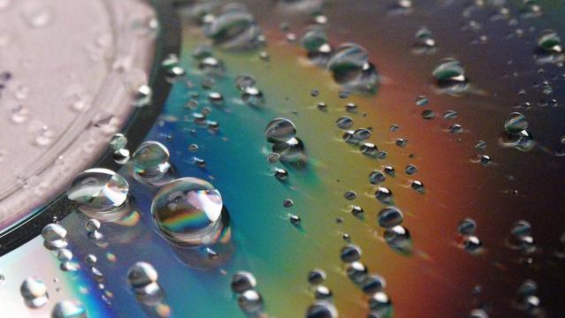 Water droplets on a iridescent surface.