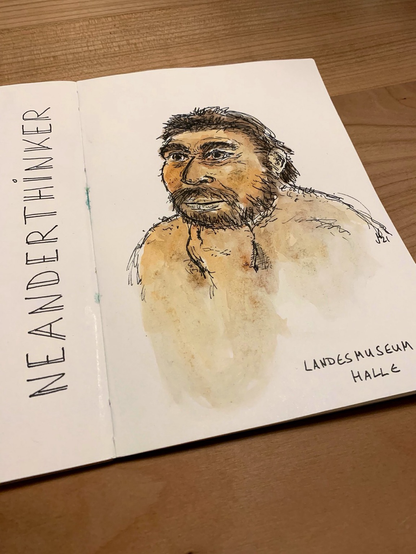 Photo of an open sketchbook showing a drawing of an reconstructed Neanderthal man in the classic "thinker pose", fist under chin.