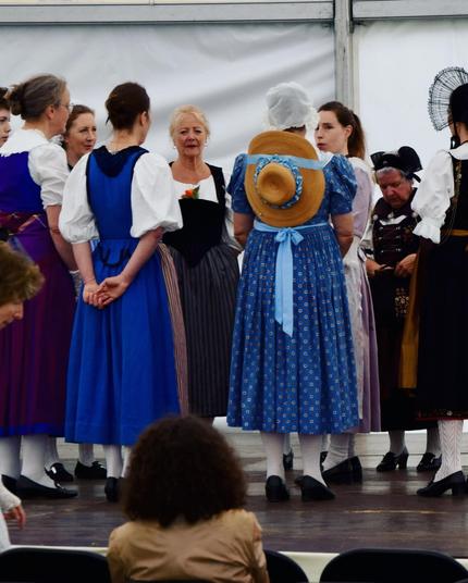 Warming up voices before the concert. Women in traditional Swiss dresses from around the country 