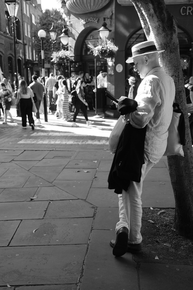 Man stands against tree