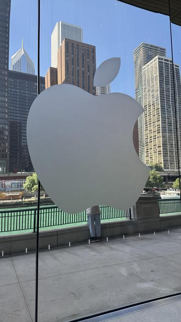 Apple Logo on a mirrored background with part of the skyline reflecting