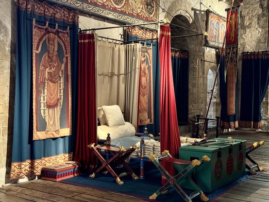 The king’s bed complete with tapestries, curtains a table and a sword! 