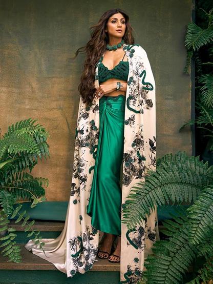 Shilpa Shetty dazzles in an emerald green Indo-Western dress, a true masterpiece of fashion fusion. This stunning ensemble combines the richness of Indian heritage with modern design, creating a look that's both timeless and trendy. Shilpa's emerald green dress is a testament to her exquisite taste and style. Dive into the details and get inspired by her fashion-forward choice. See the photos and be amazed by her beauty and elegance!