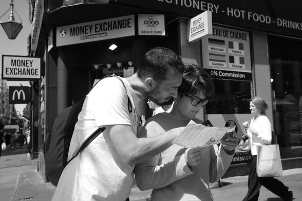 A couple look at a map on the street