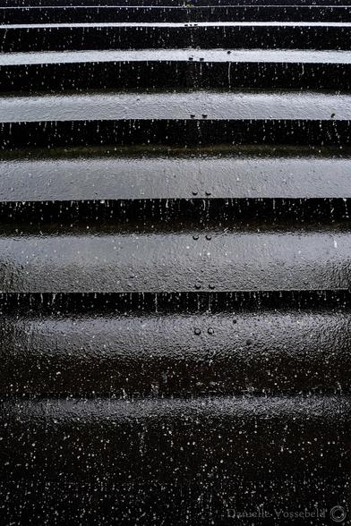 Black and white (color by the way) image of the water mill. Abstract image with lines and water drops.