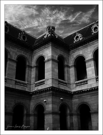 At Hotel des Invalides inner courtyard , view of old building with arched windows and doorways.