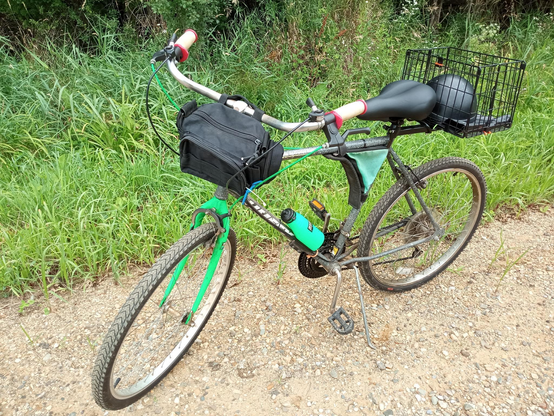 The "upright handlebars" from a "Free Spirit" 3-speed grafted onto my 1990s Huffy Stone Mountain Bike. Bike is neon green and grey with bike basket etc