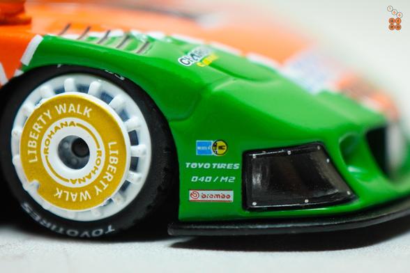 A close-up shot of Mazda RX-7 FD3S, LB-Super Silhouette Renown livery by iNNO64 in 1:64 scale with 1:64 figure on AREA 164