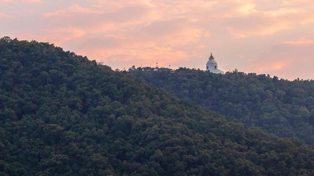 Pagoda on hilltop at sunset.