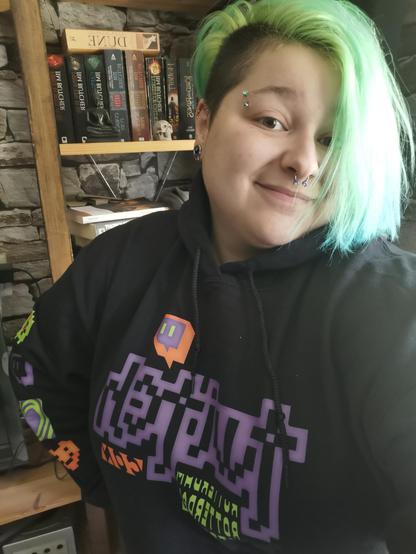 TwitchCon Rotterdam hoodie in black with neon green, Twitch purple, and bright orange decorations.