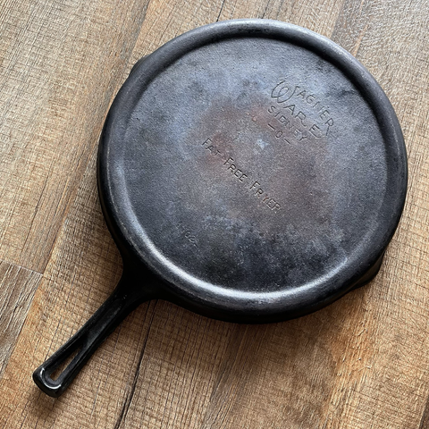 A cast iron “Wagner Fat Free Fryer” skillet