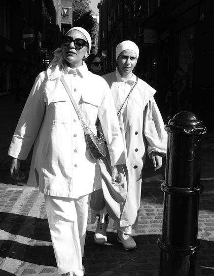 Two women walk down the street
